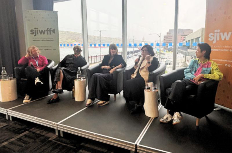 Four speakers sit on a stage during a panel discussion titled Reclaiming Space: Accessibility and Agency in Music and Media at VIFF Amp.