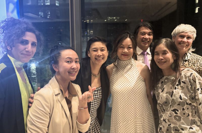 A group of people smiles at the camera